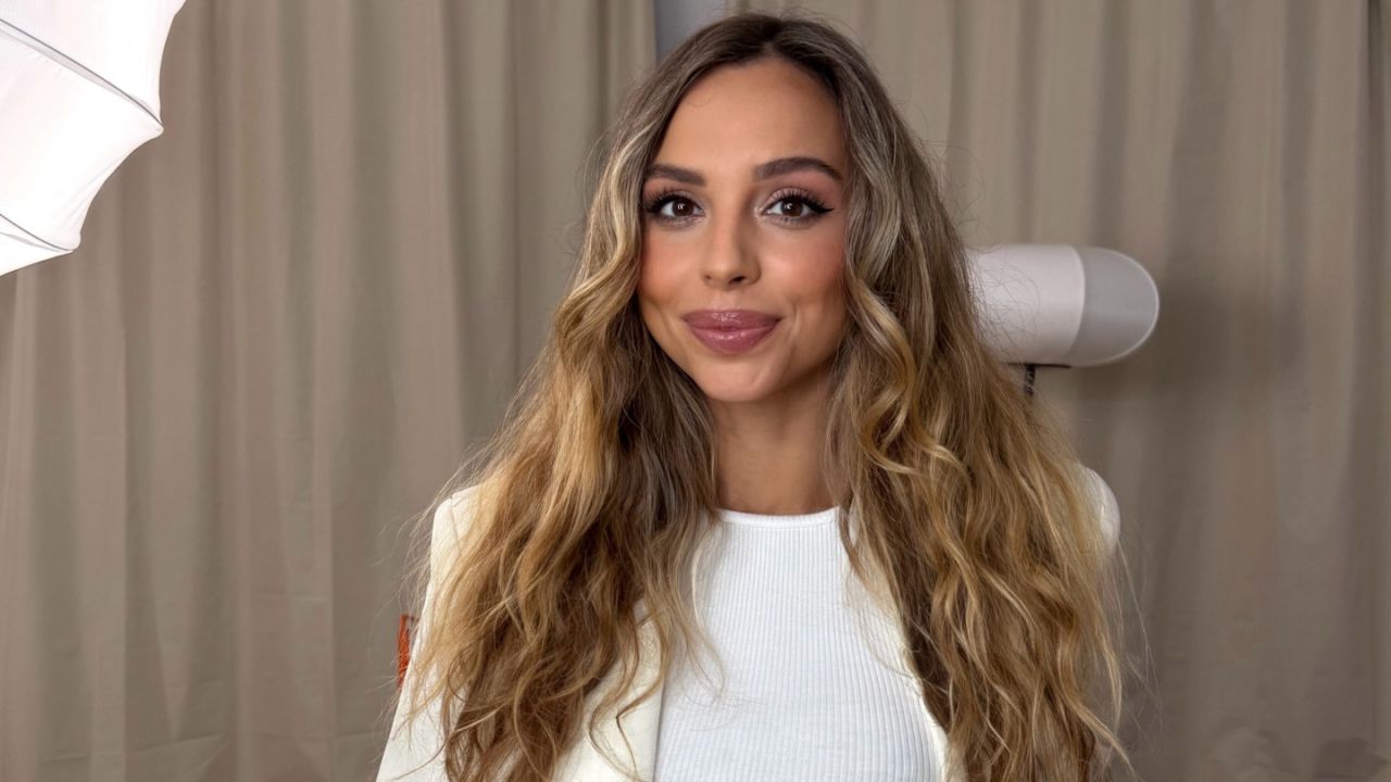 Veronica Bielik showcases a sophisticated, minimalist fashion trend by seamlessly layering a clean white top with a beautifully tailored blazer for a timeless, professional aesthetic.